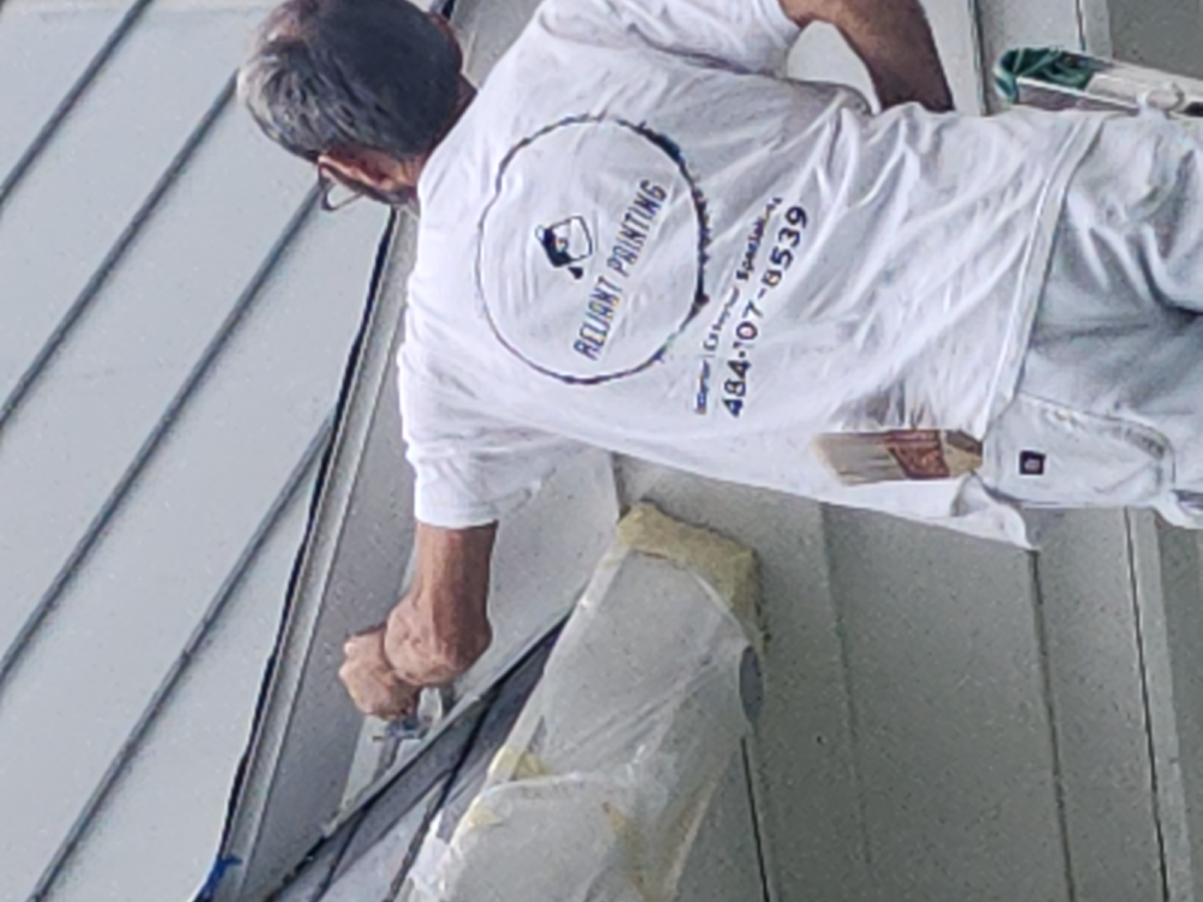 Reliant Painting craftsman at work on exterior trim
